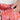 Close-up of hands adjusting the drawstring on orange patterned shorts.