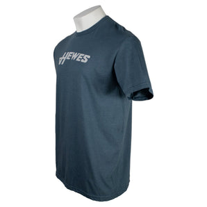 Side of a navy t-shirt with the hewes logo in grey on the chest.