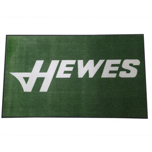 Green mat with the word 'HEWES' in white letters across it. 
